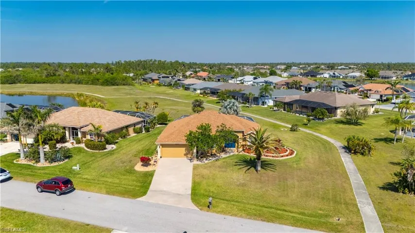 Birds eye view of property with a water view and a residential view