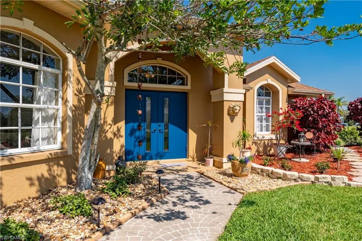 Property entrance with french doors and stucco siding