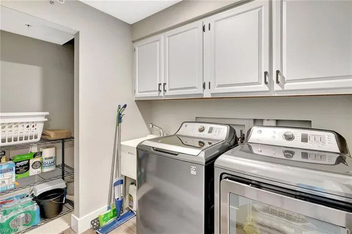 Laundry room with storage and utility sink