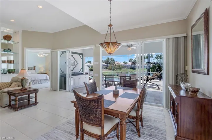 Dining area with a ceiling fan, light tile patterned floors, crown molding, and built in features