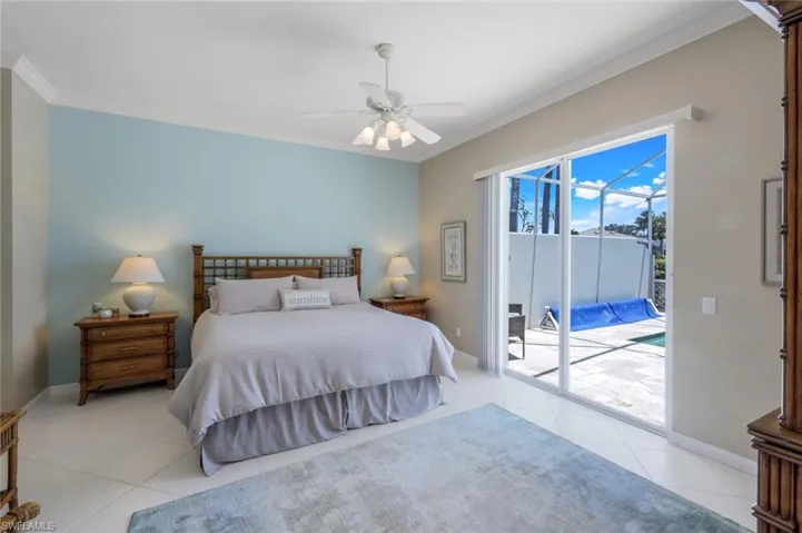 Bedroom with access to exterior, light tile patterned floors, crown molding, baseboards, and ceiling fan