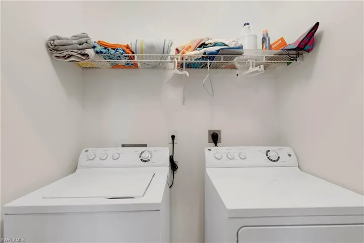 Washroom featuring washer and clothes dryer