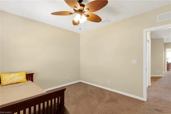 Bedroom with ceiling fan and carpet flooring