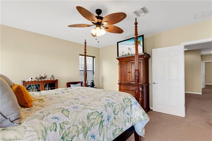 Carpeted bedroom with ceiling fan