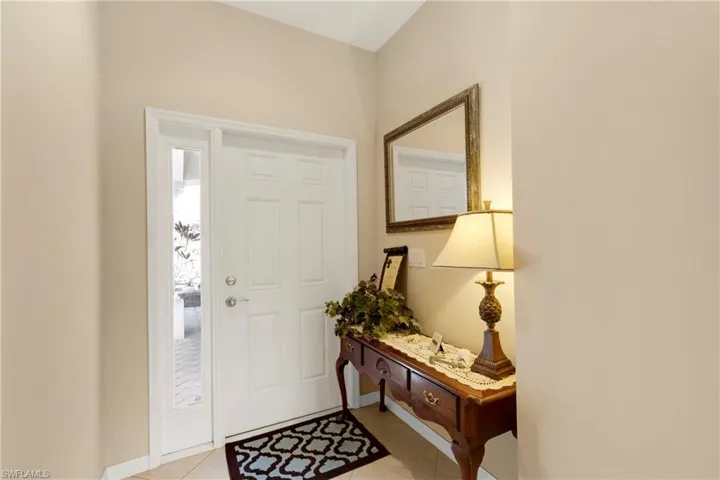 Entrance foyer featuring light tile patterned floors