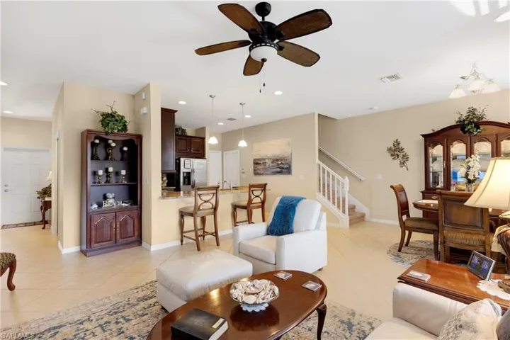 Tiled living room featuring ceiling fan