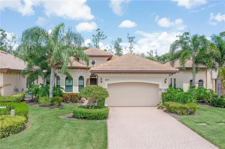Mediterranean / spanish-style home featuring a garage and a front lawn