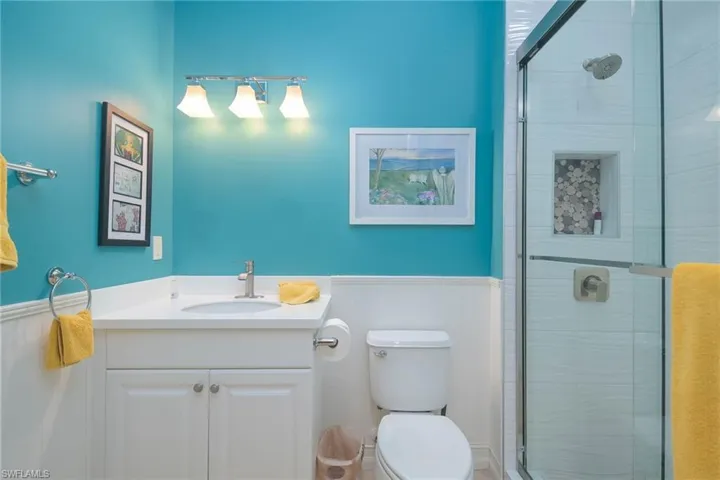 Bathroom featuring vanity, toilet, and walk in shower