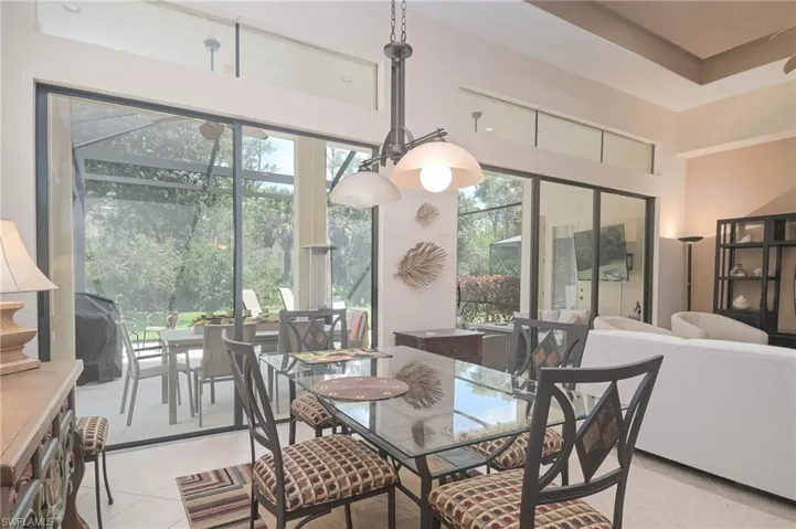 Tiled dining area featuring plenty of natural light