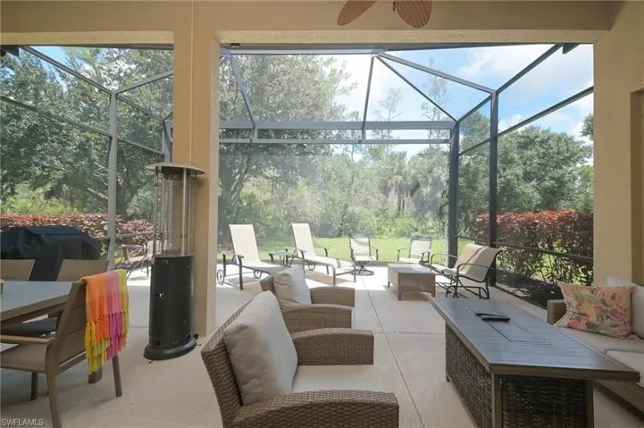Sunroom with a healthy amount of sunlight and ceiling fan