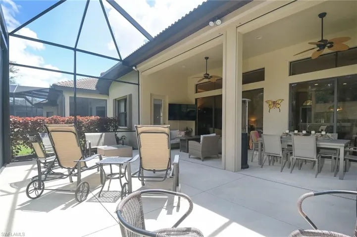View of patio / terrace with an outdoor living space, a lanai, and ceiling fan
