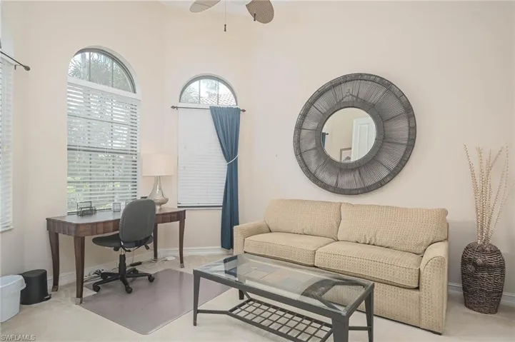 Office with light colored carpet and ceiling fan