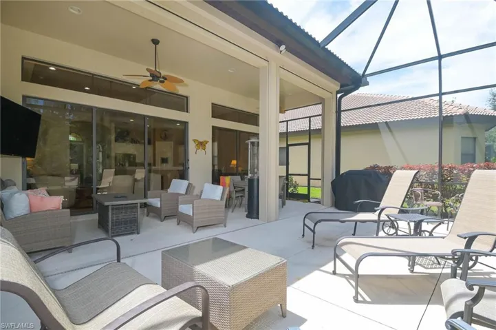 View of patio / terrace with an outdoor living space, a lanai, area for grilling, and ceiling fan