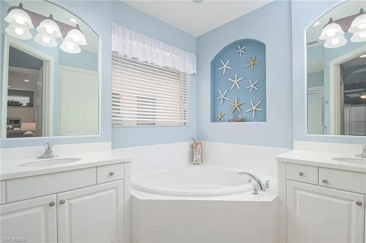 Bathroom with vanity and a relaxing tiled tub