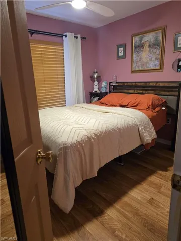 Bedroom featuring hardwood / wood-style floors and ceiling fan