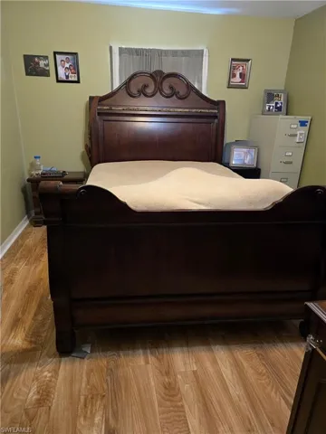 Bedroom with light hardwood / wood-style floors