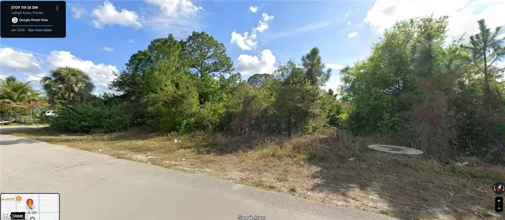 Corner lot featuring mature trees and shrubbery
