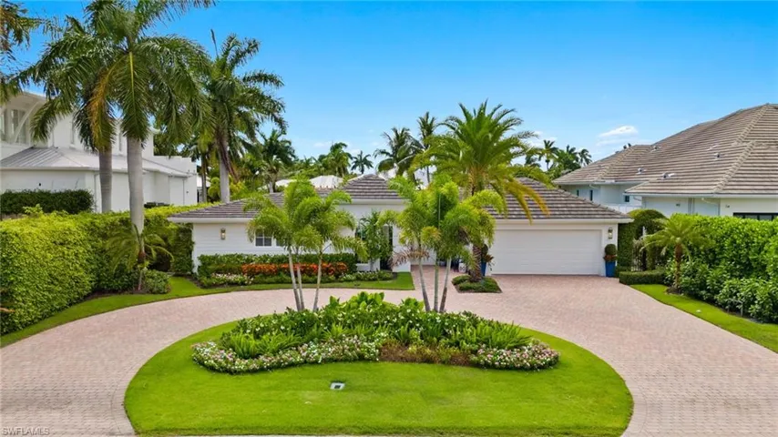 Mediterranean / spanish-style house with a garage and a front lawn