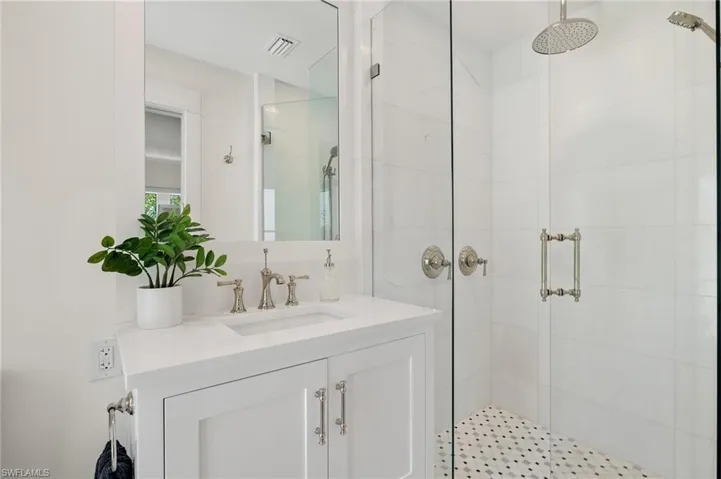 Bathroom with an enclosed shower and vanity