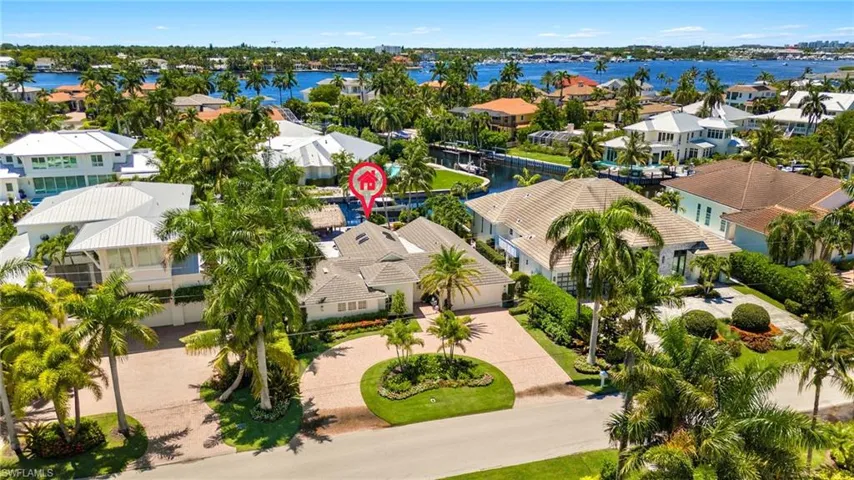 Birds eye view of property with a water view