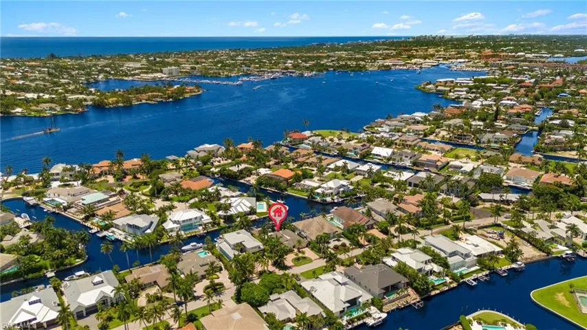 Birds eye view of property with a water view