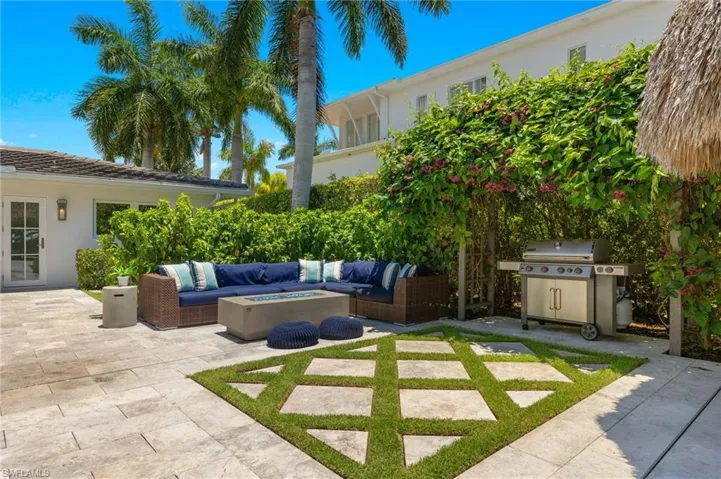 View of patio with an outdoor living space with a fire pit and grilling area