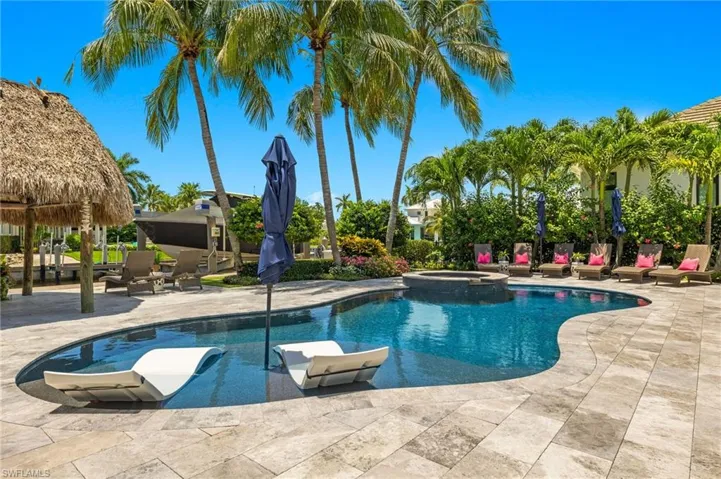 View of pool with an in ground hot tub and a patio area