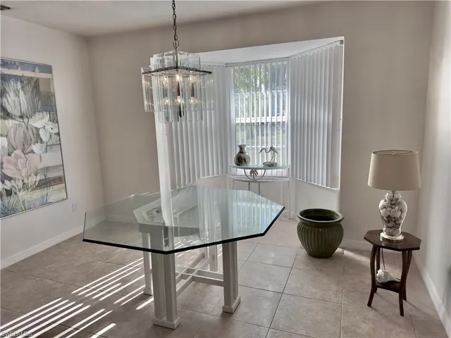 Dining room featuring a chandelier and tile patterned floors