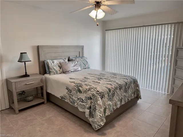 Bedroom featuring light tile patterned flooring and ceiling fan