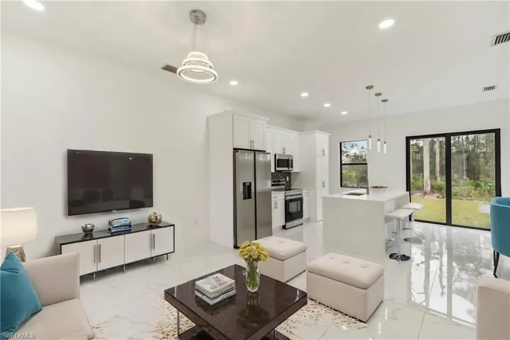 Living room featuring an inviting chandelier and sink