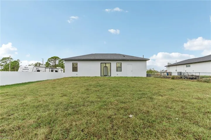 Rear view of property featuring a lawn