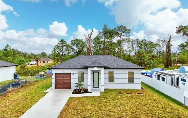 View of front of house with a front yard and a garage