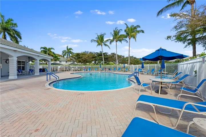 Community pool with a patio