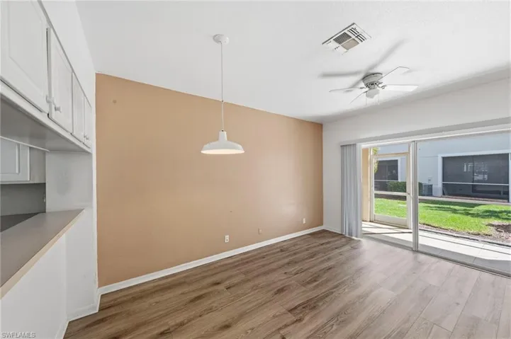 Unfurnished dining area featuring wood finished floors and ceiling fan
