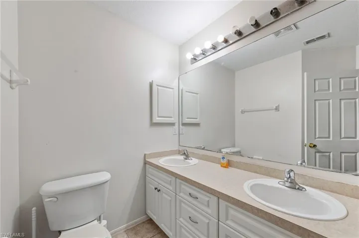 Bathroom with toilet and double vanity