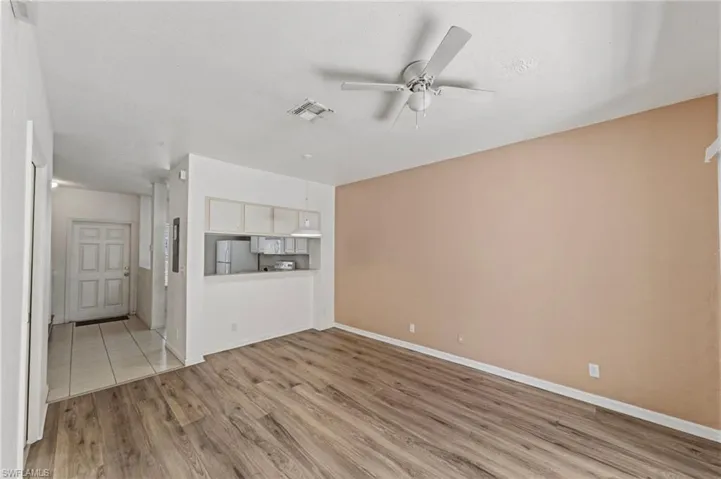 Unfurnished living room with light wood-style flooring and a ceiling fan
