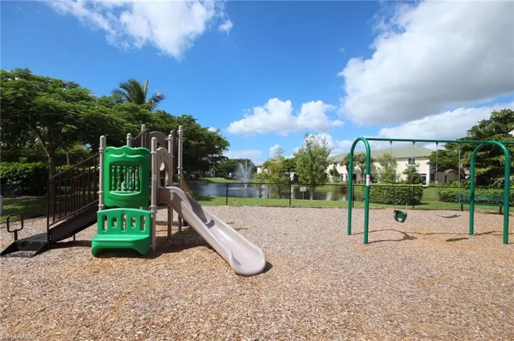 Community playground featuring a water view