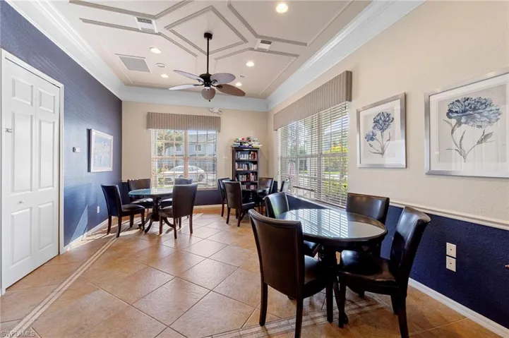 Dining area with recessed lighting, crown molding, coffered ceiling, ceiling fan, and healthy amount of natural light