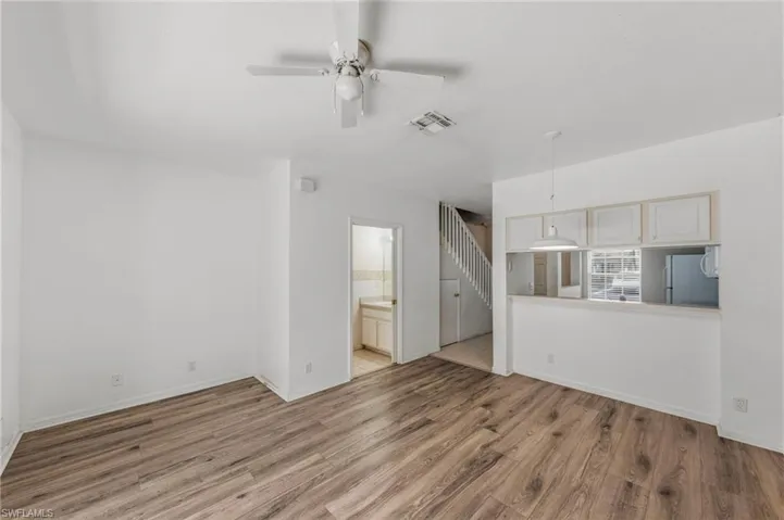 Unfurnished living room featuring light wood-style flooring and ceiling fan