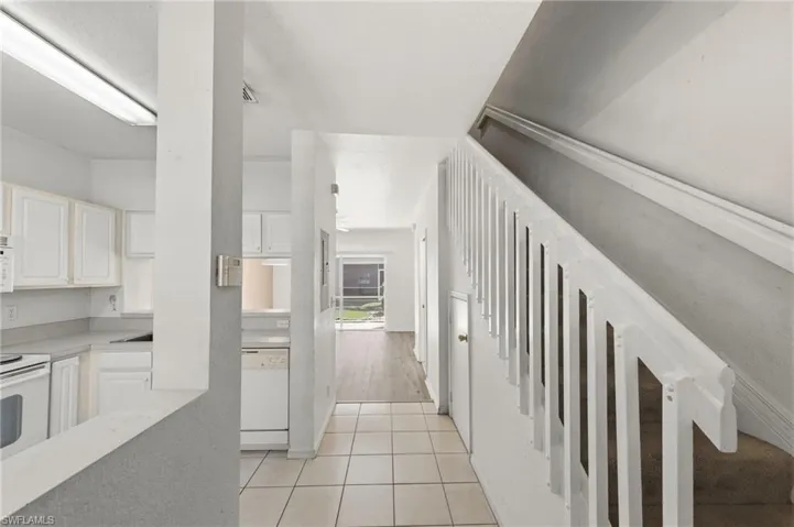 Hall with light tile patterned flooring