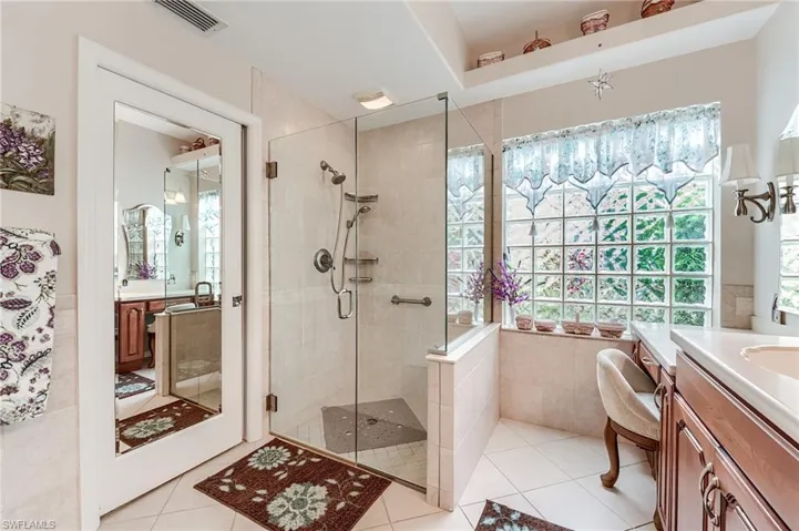 Full bath featuring visible vents, a shower stall, vanity, and tile patterned flooring