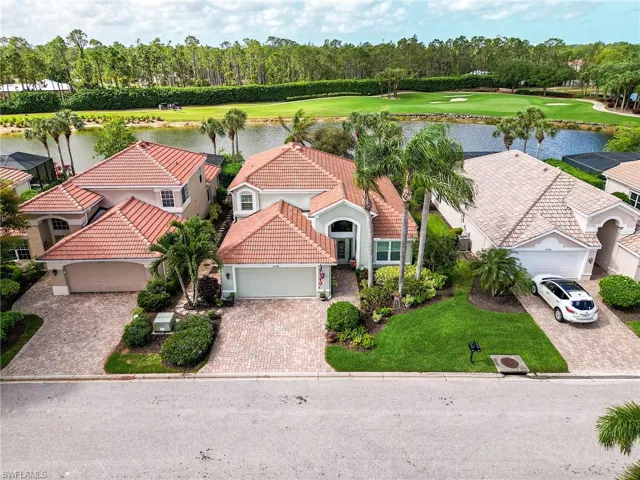 Aerial view featuring a water view and view of golf course