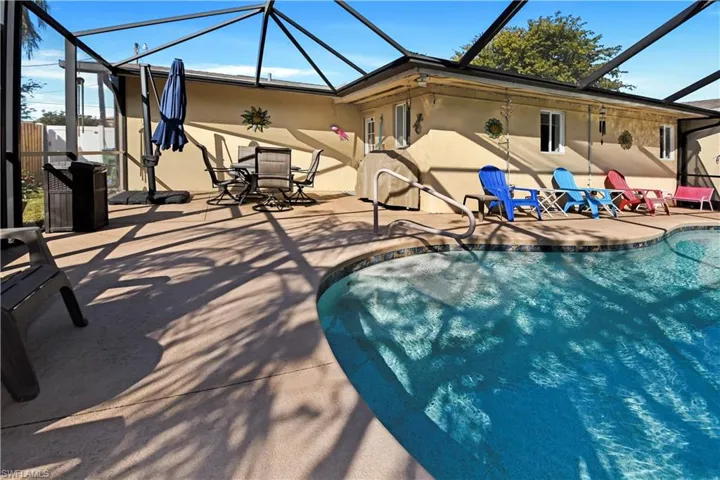 Outdoor pool featuring a lanai, a sunroom, and a patio