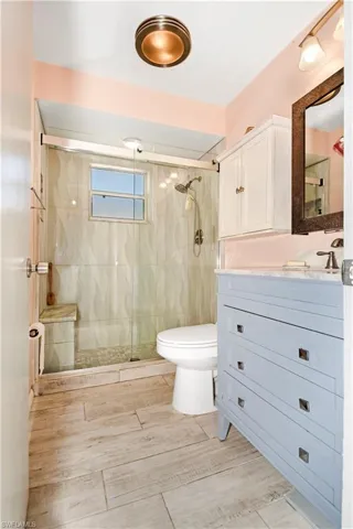 Full bathroom featuring a stall shower and vanity
