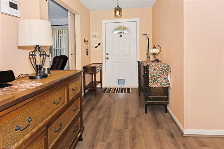 Entryway featuring dark wood-type flooring and baseboards