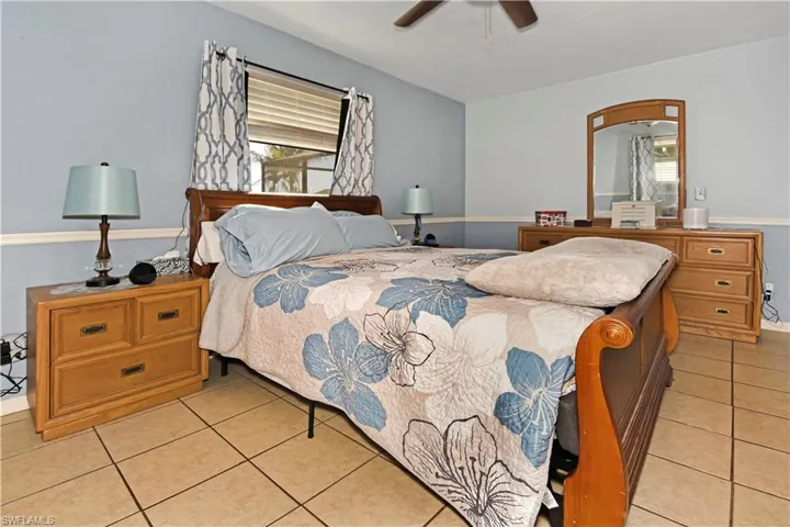 Bedroom featuring light tile patterned floors and a ceiling fan