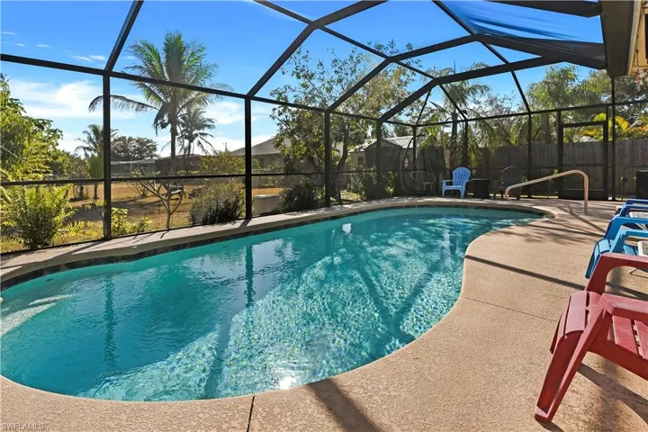 View of pool featuring a sunroom, a lanai, and patio surround