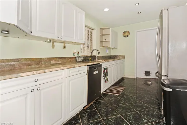 Kitchen featuring white cabinetry, open shelves, stainless steel appliances, and recessed lighting