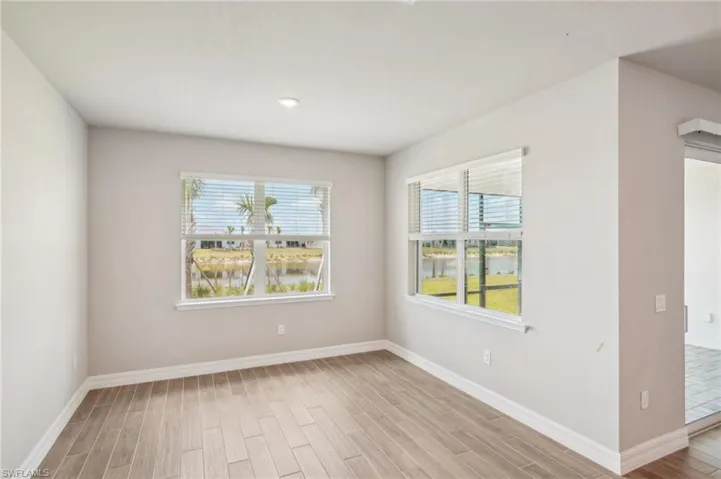 Spare room featuring wood finished floors and baseboards