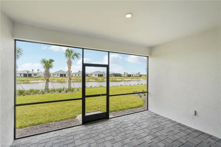 Unfurnished sunroom with a water view and a residential view